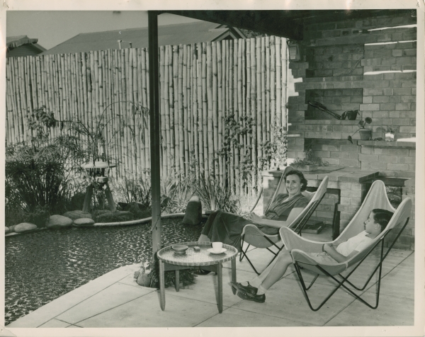Black and white photograph of Karl and Gertrude Langer sitting in a garden overlooking a pond.