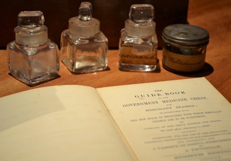 The guide book from the medical cabinet, pictured with 4 containers of medical substances