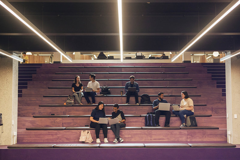 Students sitting on the purple stairs in Central Library.