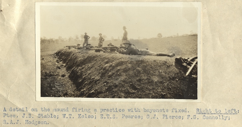 A detail on the mound firing a practice with bayonets fixed. Right to left Ptee. J.B. Stable; W.T. Kelso; E.T.S. Pearce; G.J. Pierce; F.G. Connolly; R.A.J. Hodgson.