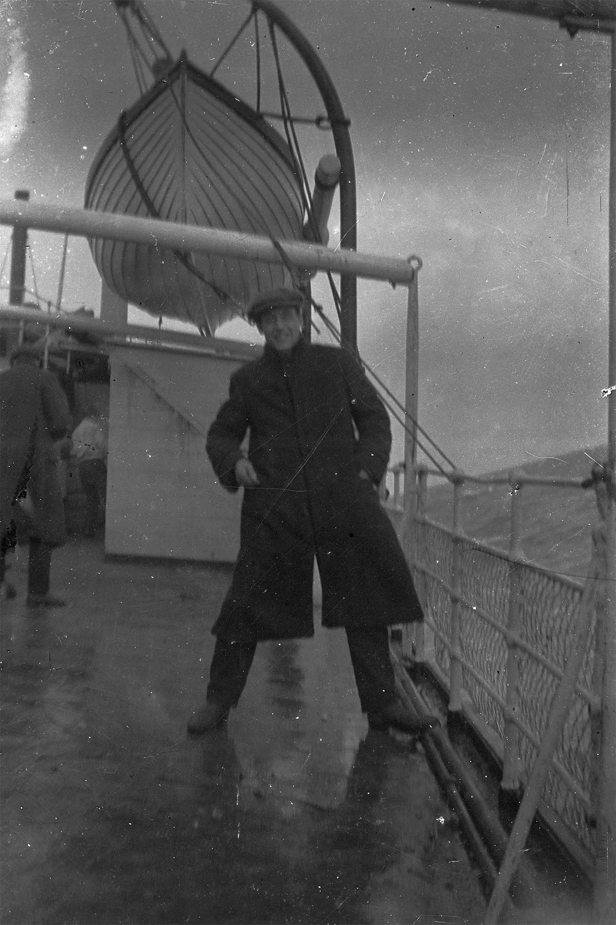 Man on deck of a passenger ship, during rough sea c1900s