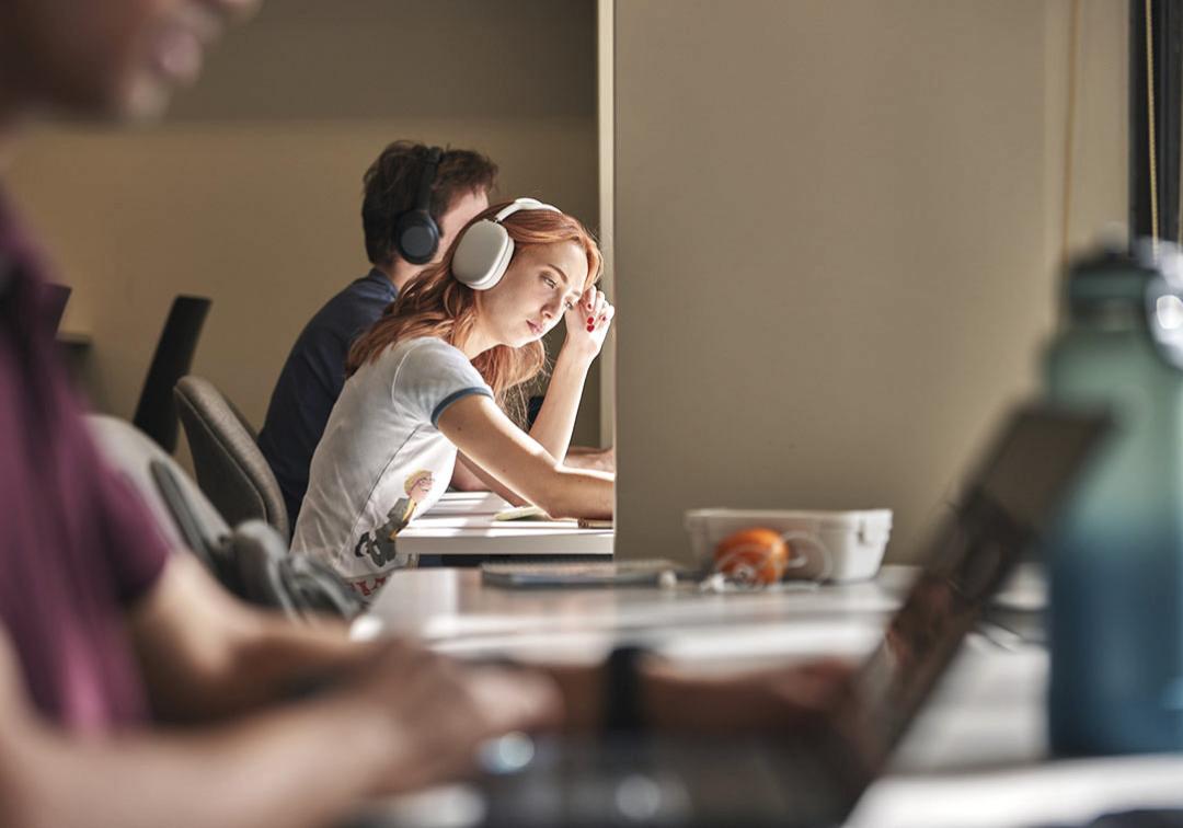 students with headphones on laptop