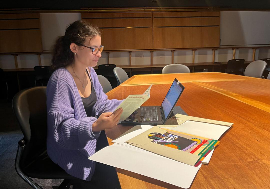 Jessica Andrews browsing special collections material in the Fryer Library. 