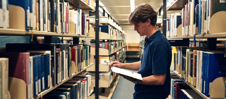 student browsing book in the library 