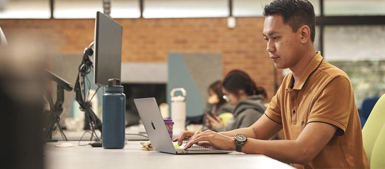 student with laptop and computer in jk murray library