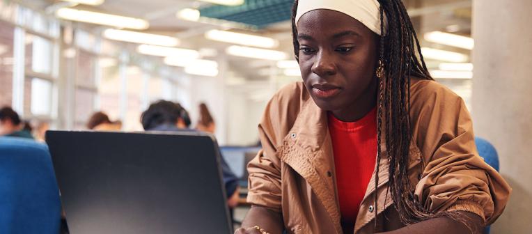 student using laptop in engineering library