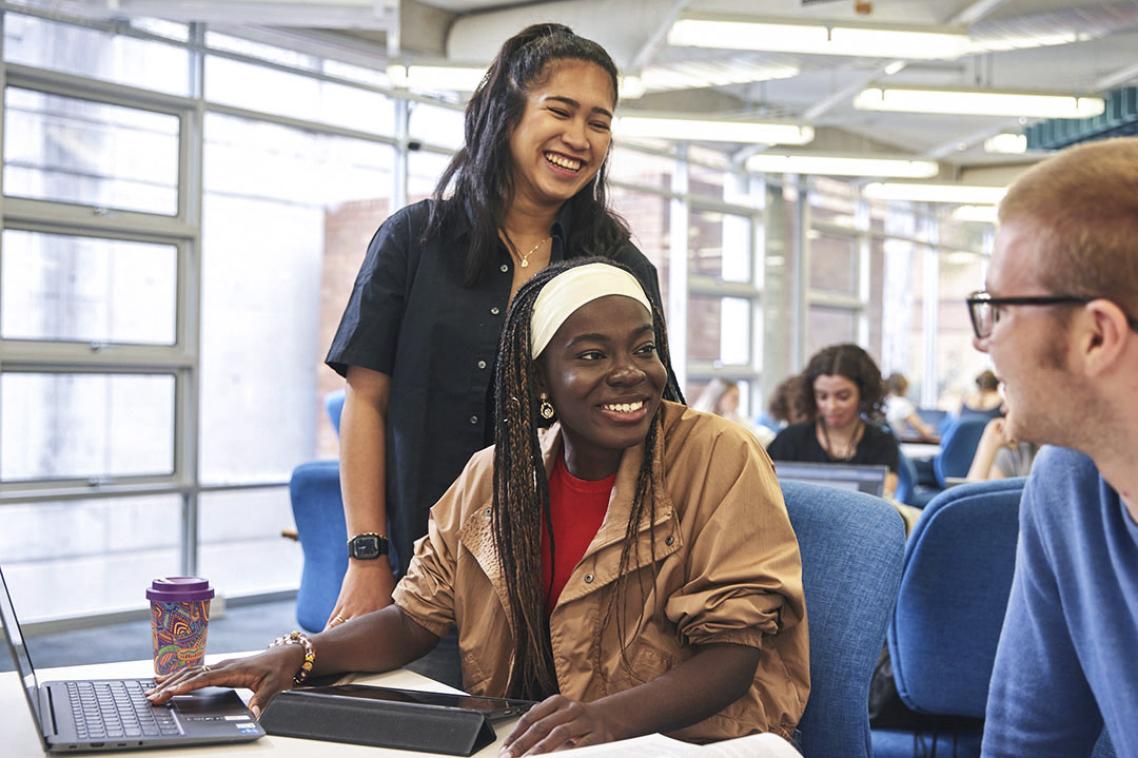 students talking together at desk