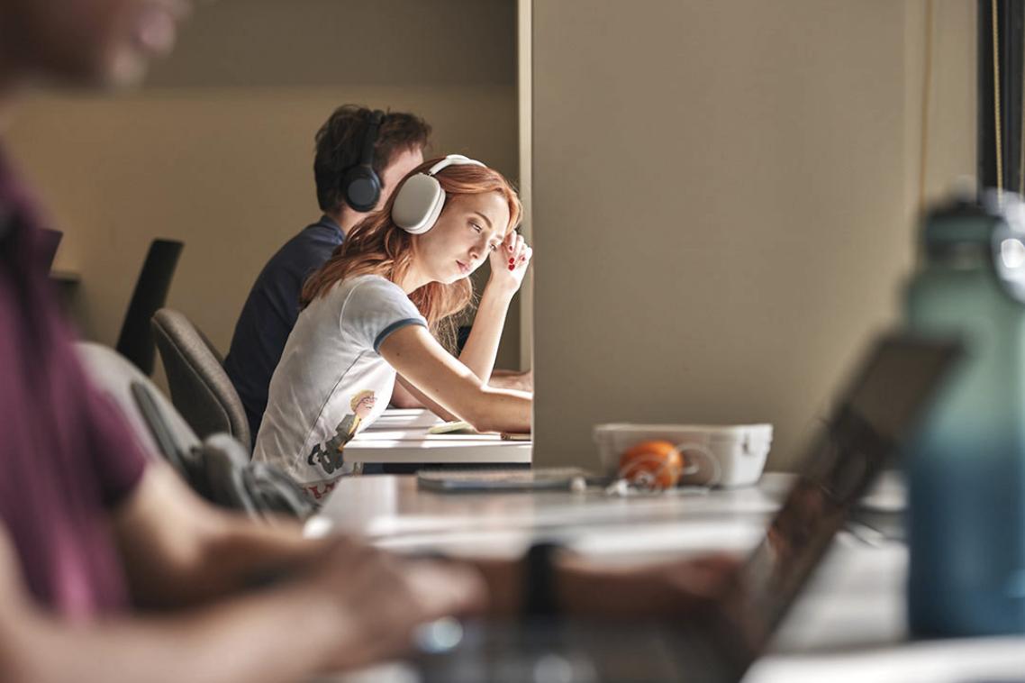 students with headphones on laptop