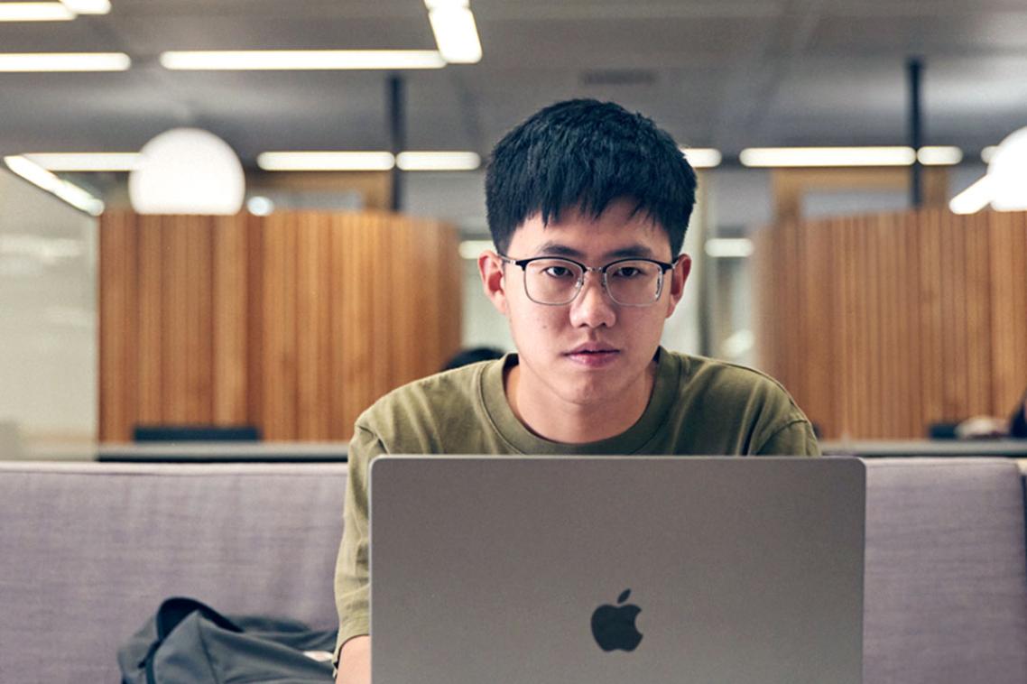 student using laptop central library