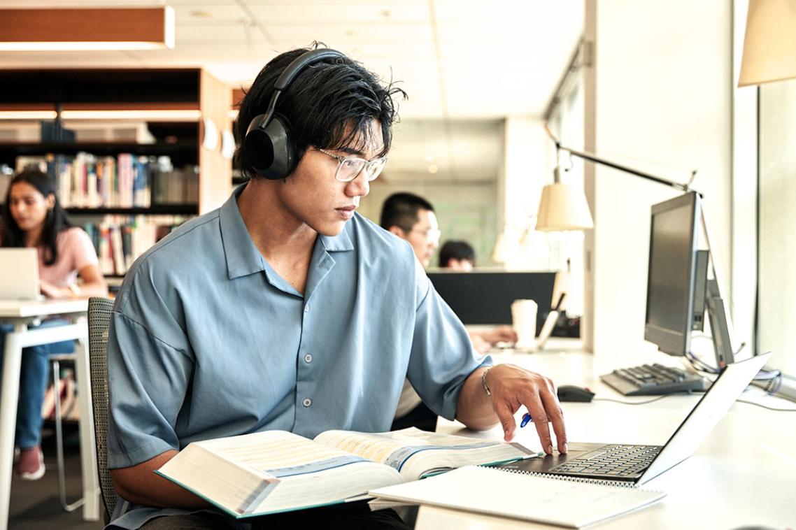 Student studying on a laptop.