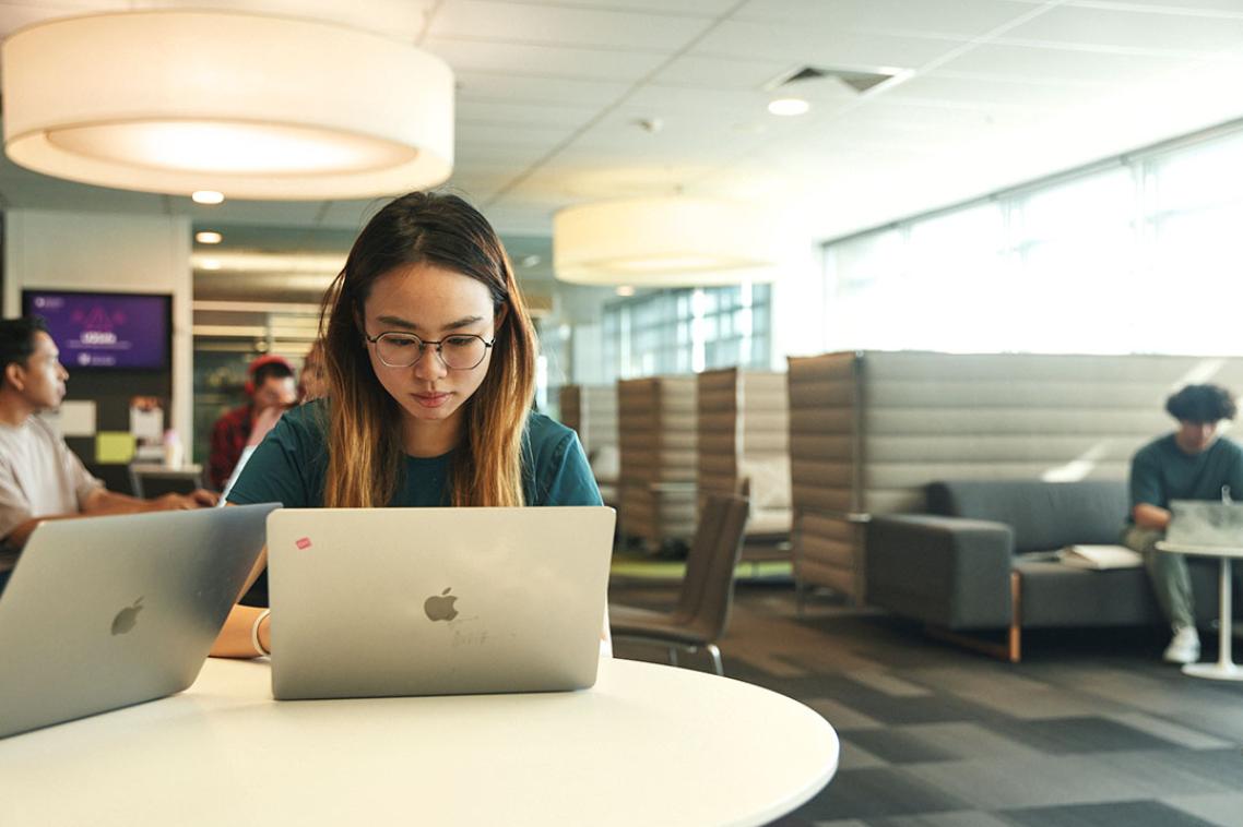 Student looking at laptop on a desk